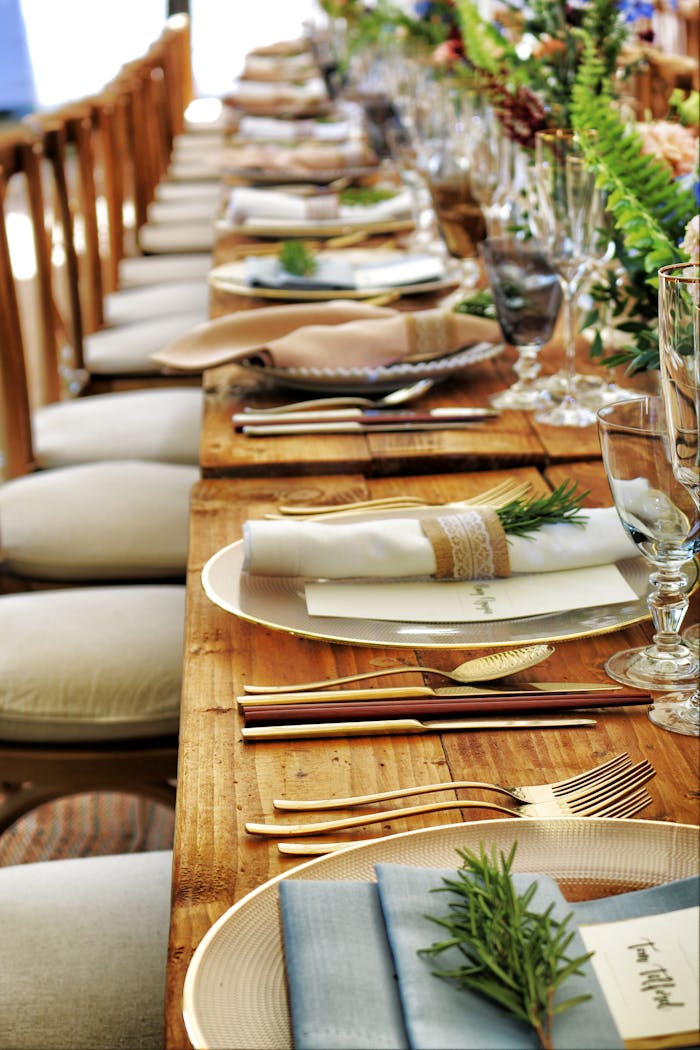 Close-up of a beautifully arranged table setting with flowers and cutlery, perfect for weddings or fine dining.